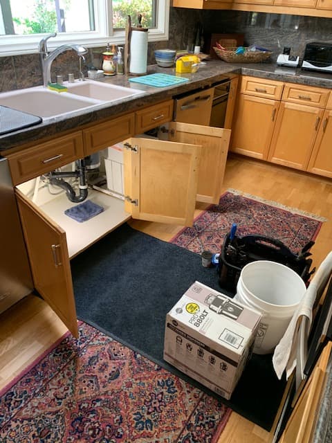 Kitchen sink undergoing plumbing service