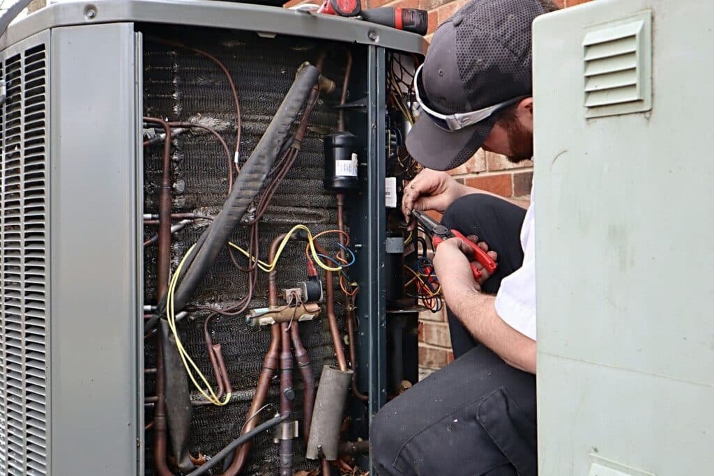 service repair being done on a heat pump.2403210553550